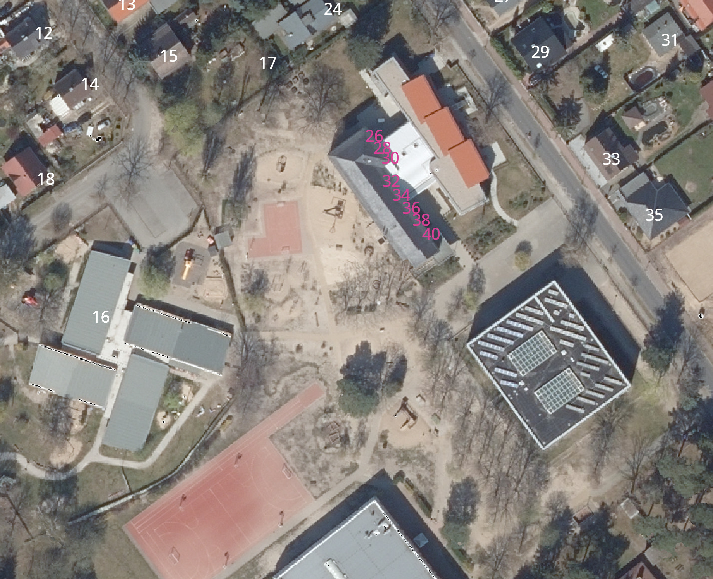 Aerial view of a school campus with several house numbers